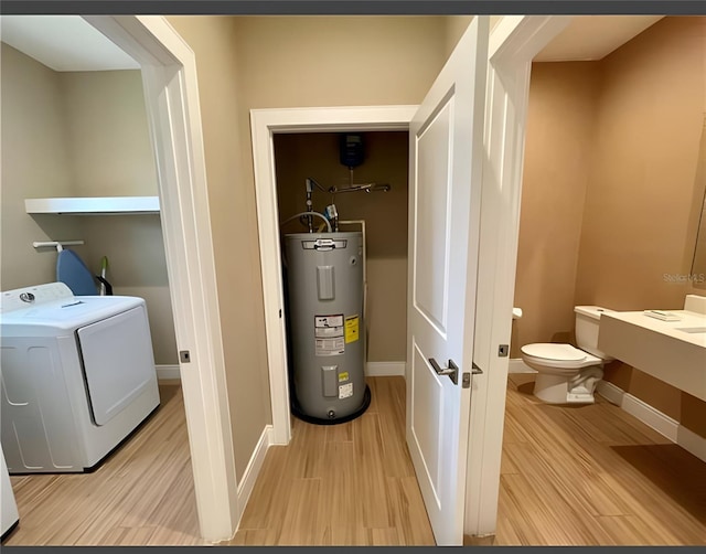 washroom with washer / clothes dryer, water heater, and light hardwood / wood-style floors