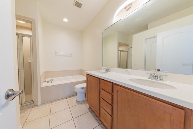 full bathroom with tile patterned flooring, shower with separate bathtub, vanity, and toilet