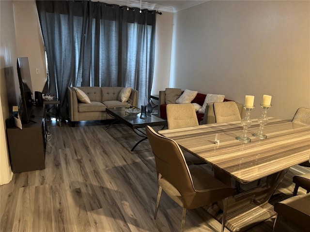 dining room featuring ornamental molding and hardwood / wood-style floors