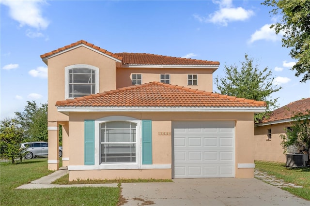 mediterranean / spanish-style home with a garage, a front yard, and central AC