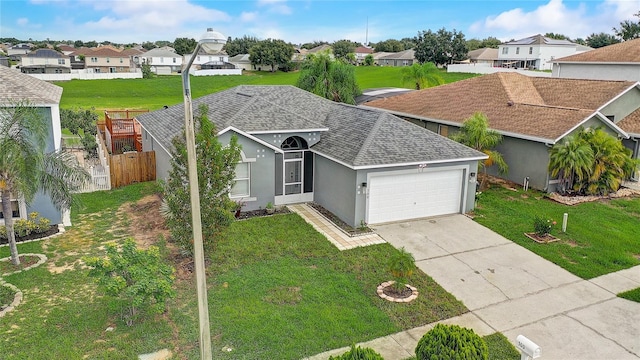 ranch-style house featuring a garage and a front yard