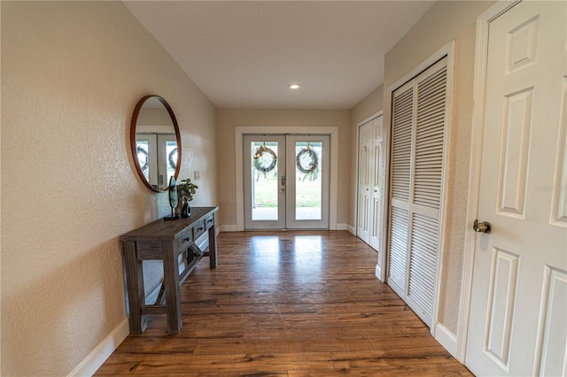 entrance foyer with french doors and dark wood-type flooring