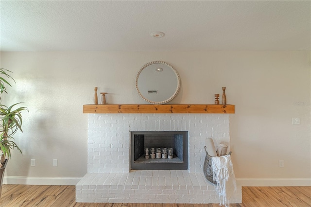 room details with a brick fireplace and hardwood / wood-style flooring