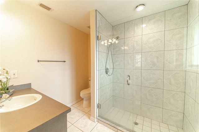 bathroom featuring tile patterned flooring, vanity, an enclosed shower, and toilet