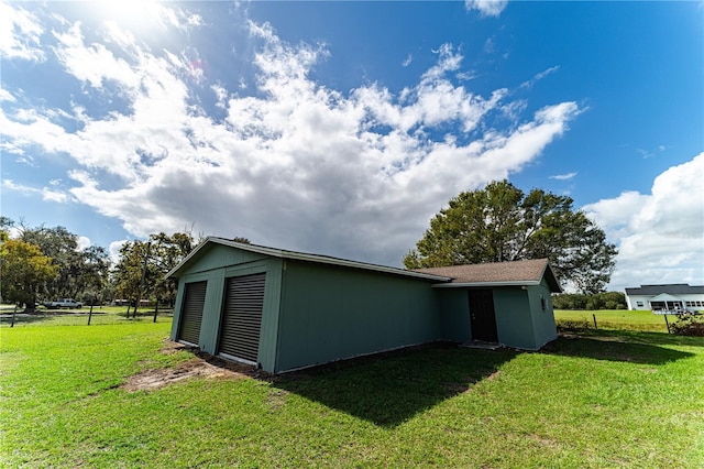 view of outdoor structure featuring a yard and a garage