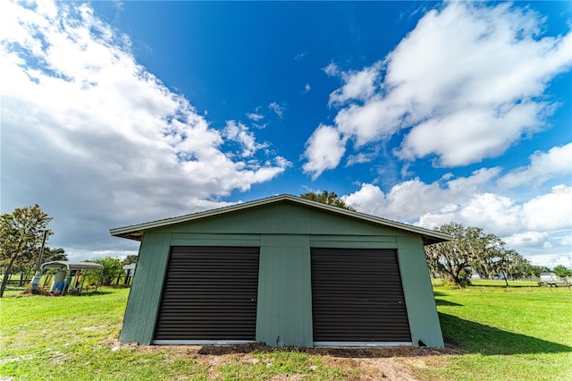 garage featuring a lawn