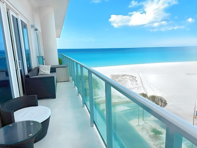 balcony with a view of the beach and a water view