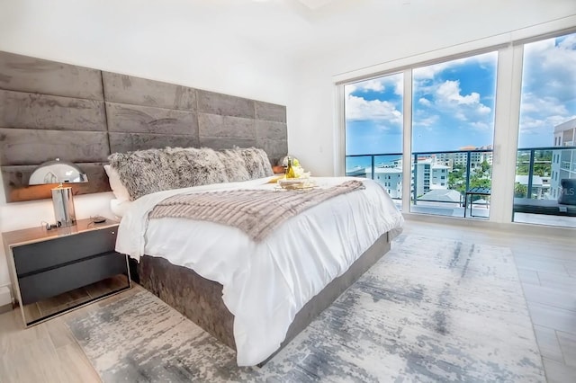 bedroom featuring access to outside and hardwood / wood-style floors