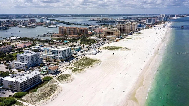 drone / aerial view with a water view and a beach view