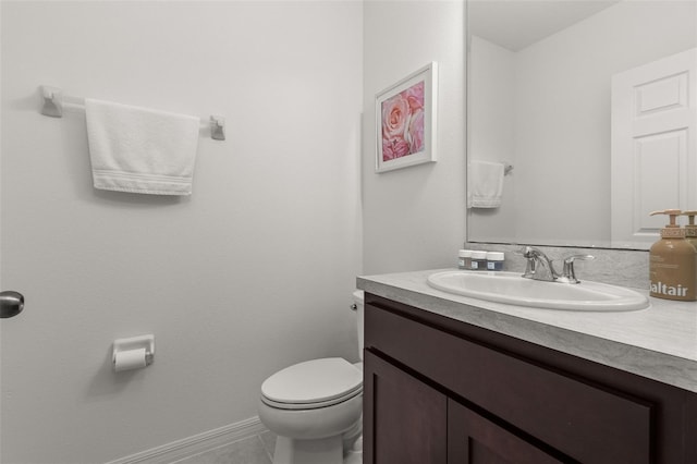 bathroom featuring tile patterned flooring, vanity, and toilet