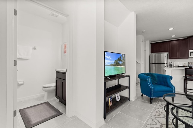 4919 Conifer Cone Dr, Kissimmee, FL 34746 - living room featuring light tile patterned floors, recessed lighting, and baseboards