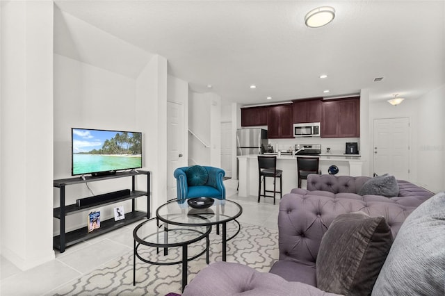 4919 Conifer Cone Dr, Kissimmee, FL 34746 - living room featuring light tile patterned floors and recessed lighting