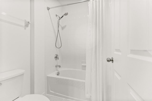 bathroom featuring toilet and shower / bathtub combination with curtain