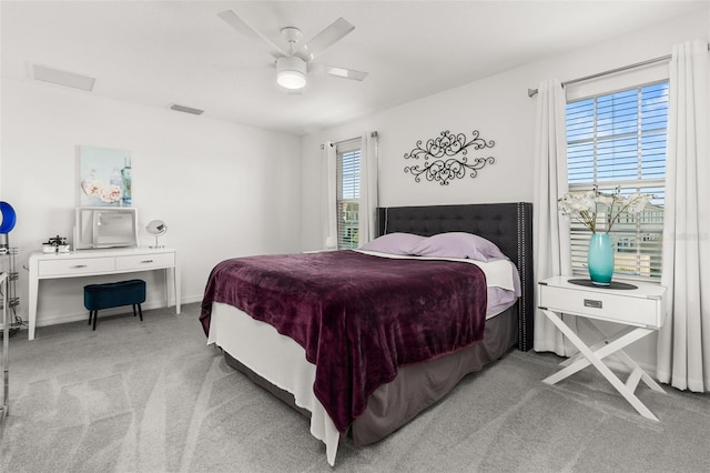 bedroom featuring ceiling fan and light carpet