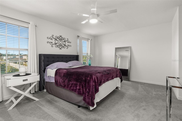 bedroom featuring multiple windows, carpet flooring, and ceiling fan