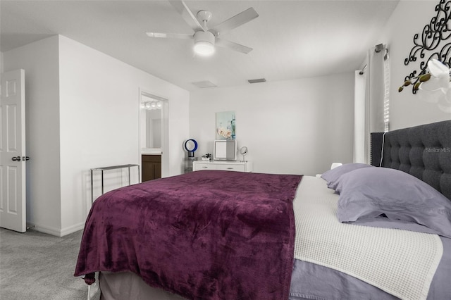 bedroom featuring ensuite bathroom, ceiling fan, and light colored carpet