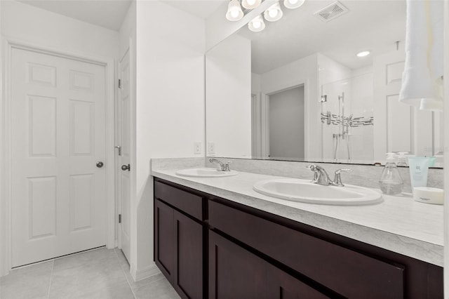 bathroom featuring vanity, a shower with shower door, and tile patterned floors