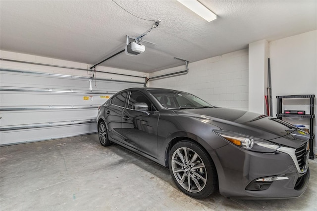 4919 Conifer Cone Dr, Kissimmee, FL 34746 - garage featuring a garage door opener and concrete block wall