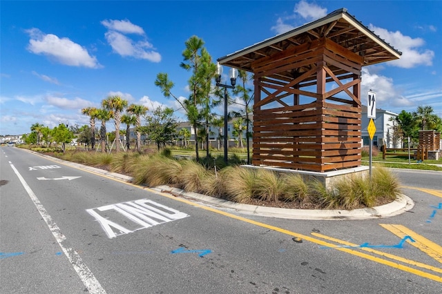 4919 Conifer Cone Dr, Kissimmee, FL 34746 - view of asphalt road featuring curbs and traffic signs