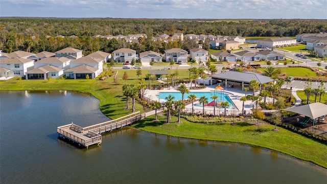 4919 Conifer Cone Dr, Kissimmee, FL 34746 - aerial perspective of suburban area featuring a pool, a nearby body of water, and a heavily wooded area
