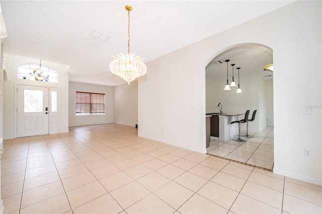 interior space featuring sink, light tile patterned floors, and a notable chandelier