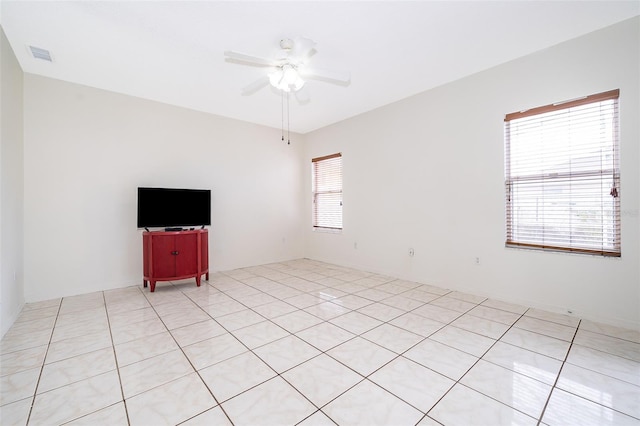 spare room featuring ceiling fan and light tile patterned flooring