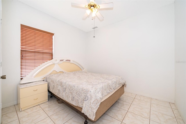 tiled bedroom featuring ceiling fan