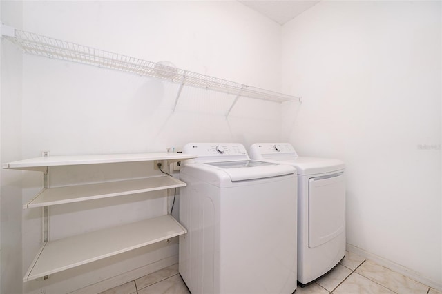 washroom featuring light tile patterned flooring and separate washer and dryer