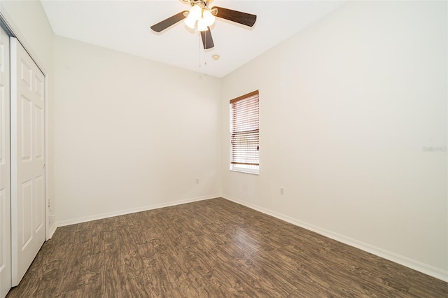 unfurnished bedroom featuring dark wood-type flooring, ceiling fan, and a closet