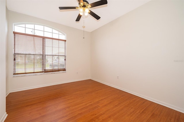 unfurnished room featuring hardwood / wood-style floors, ceiling fan, and vaulted ceiling