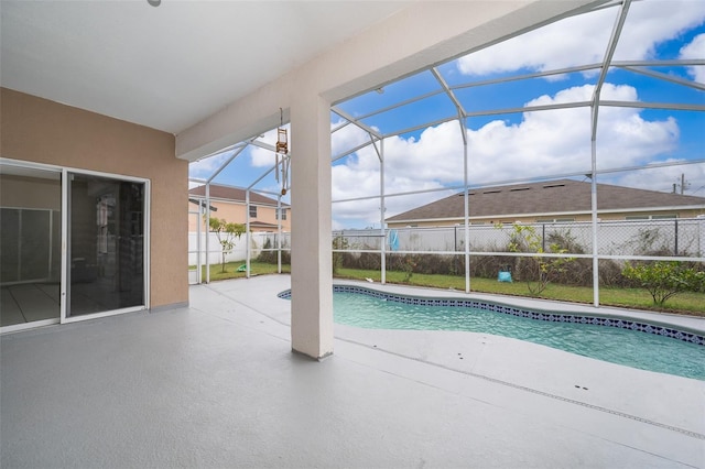 view of swimming pool featuring a patio and a lanai