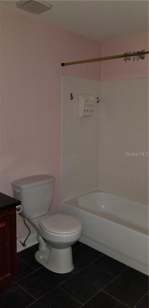 full bathroom with tile patterned floors, vanity, toilet, and shower / washtub combination