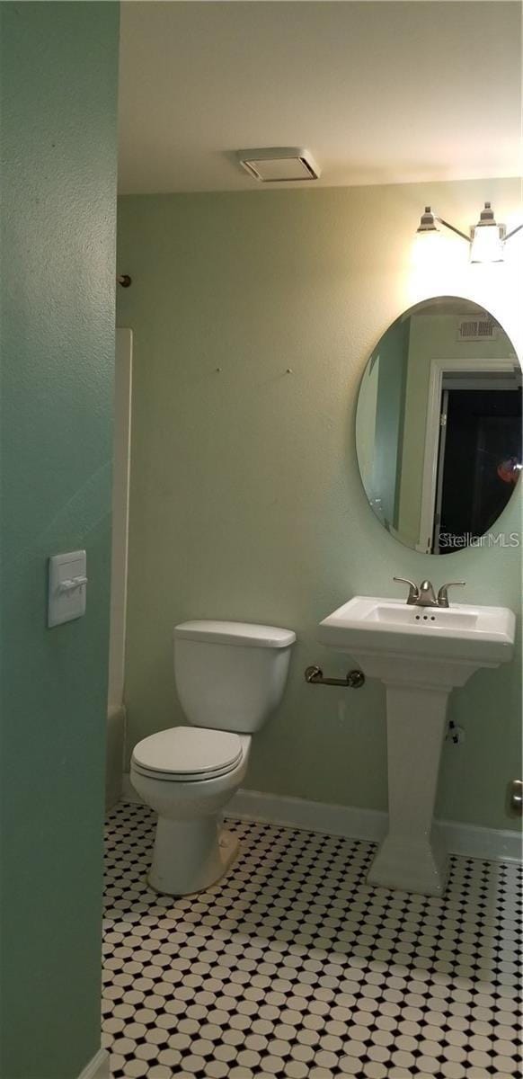 bathroom featuring tile patterned flooring and toilet