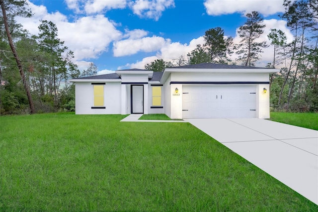 view of front of house featuring a garage and a front yard