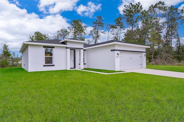 view of front of property with a garage and a front lawn