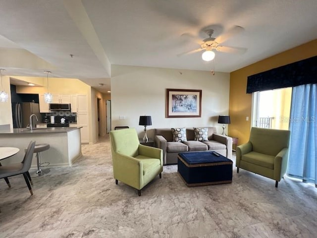 living room featuring ceiling fan and sink