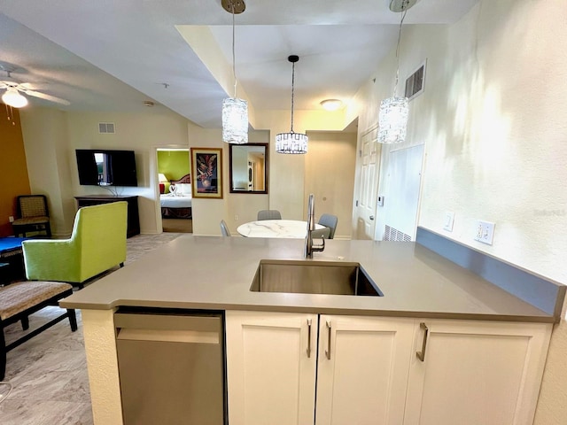 kitchen featuring white cabinets, ceiling fan, sink, and hanging light fixtures