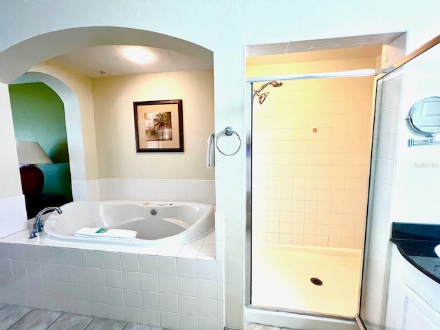 bathroom with shower with separate bathtub and vanity