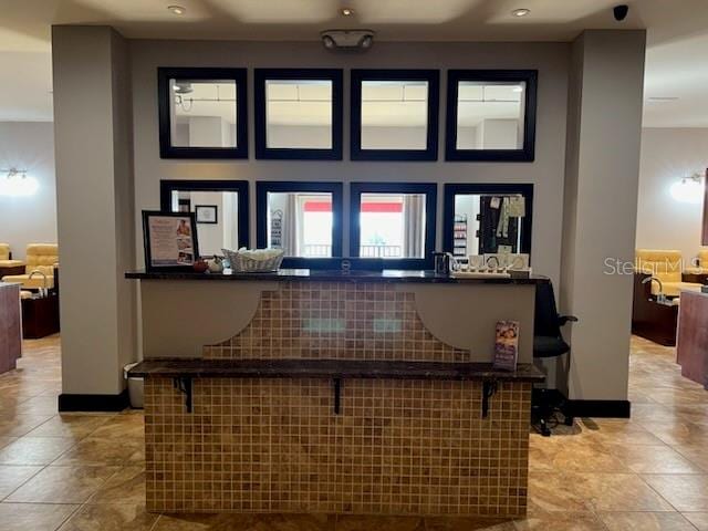 kitchen featuring a kitchen bar and light tile patterned floors