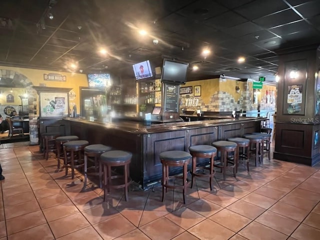 bar featuring tile patterned flooring and tasteful backsplash