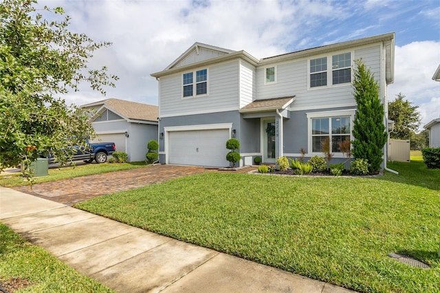 view of front of property featuring a front yard and a garage