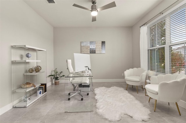 tiled office space featuring ceiling fan