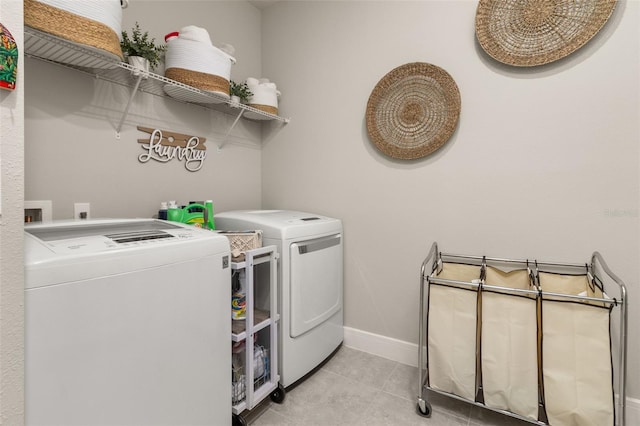 laundry area featuring light tile patterned floors and washer and dryer