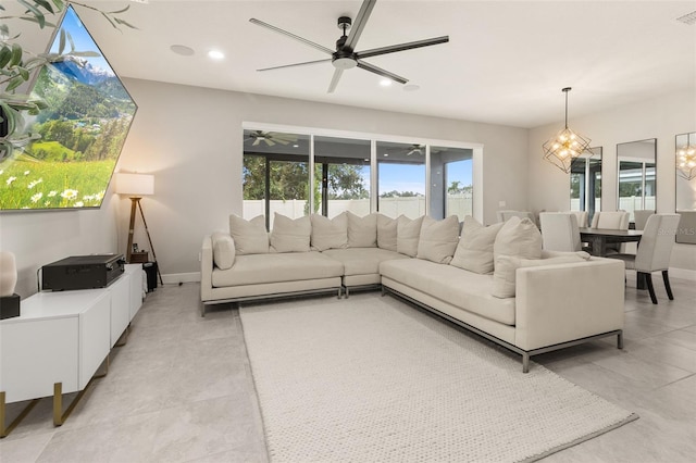 living room featuring ceiling fan with notable chandelier