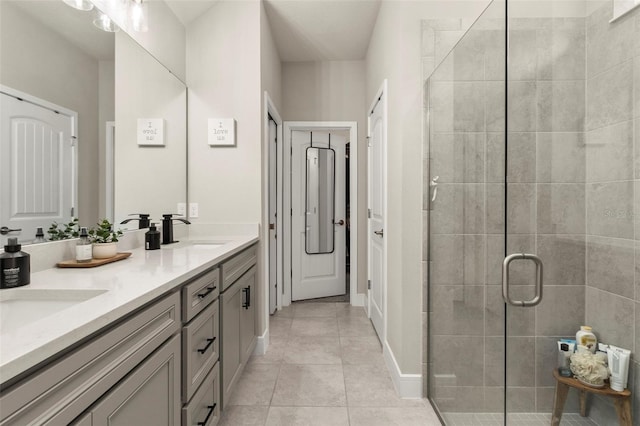 bathroom with vanity, a shower with shower door, and tile patterned flooring