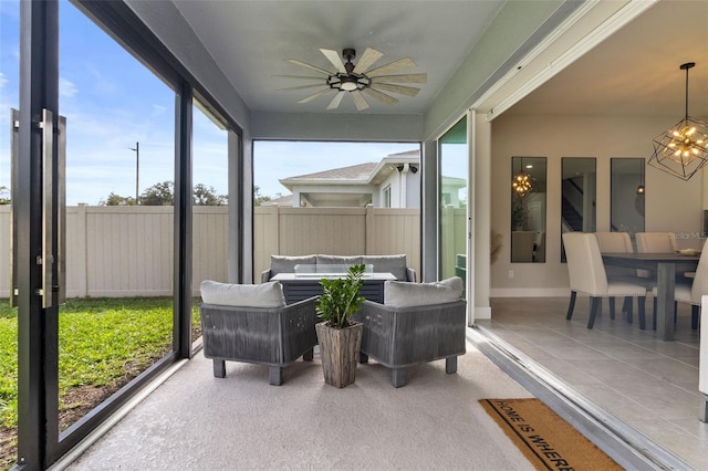 sunroom / solarium with ceiling fan with notable chandelier