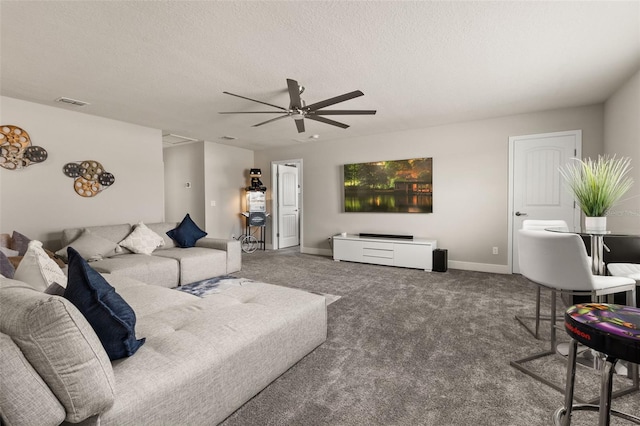 living room with ceiling fan, carpet, and a textured ceiling