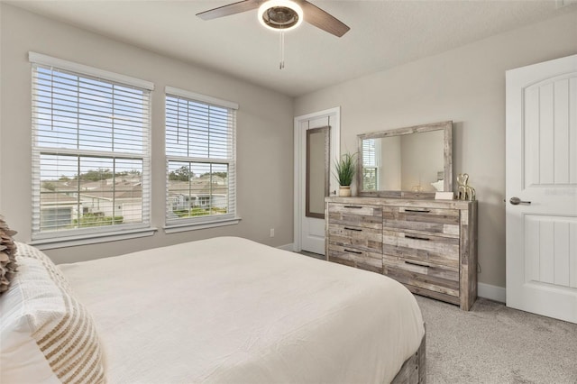 bedroom with a textured ceiling, carpet floors, and ceiling fan