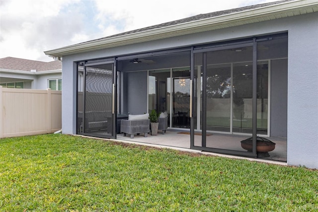 rear view of house with a yard and a sunroom