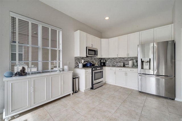 kitchen with white cabinetry, appliances with stainless steel finishes, and decorative backsplash